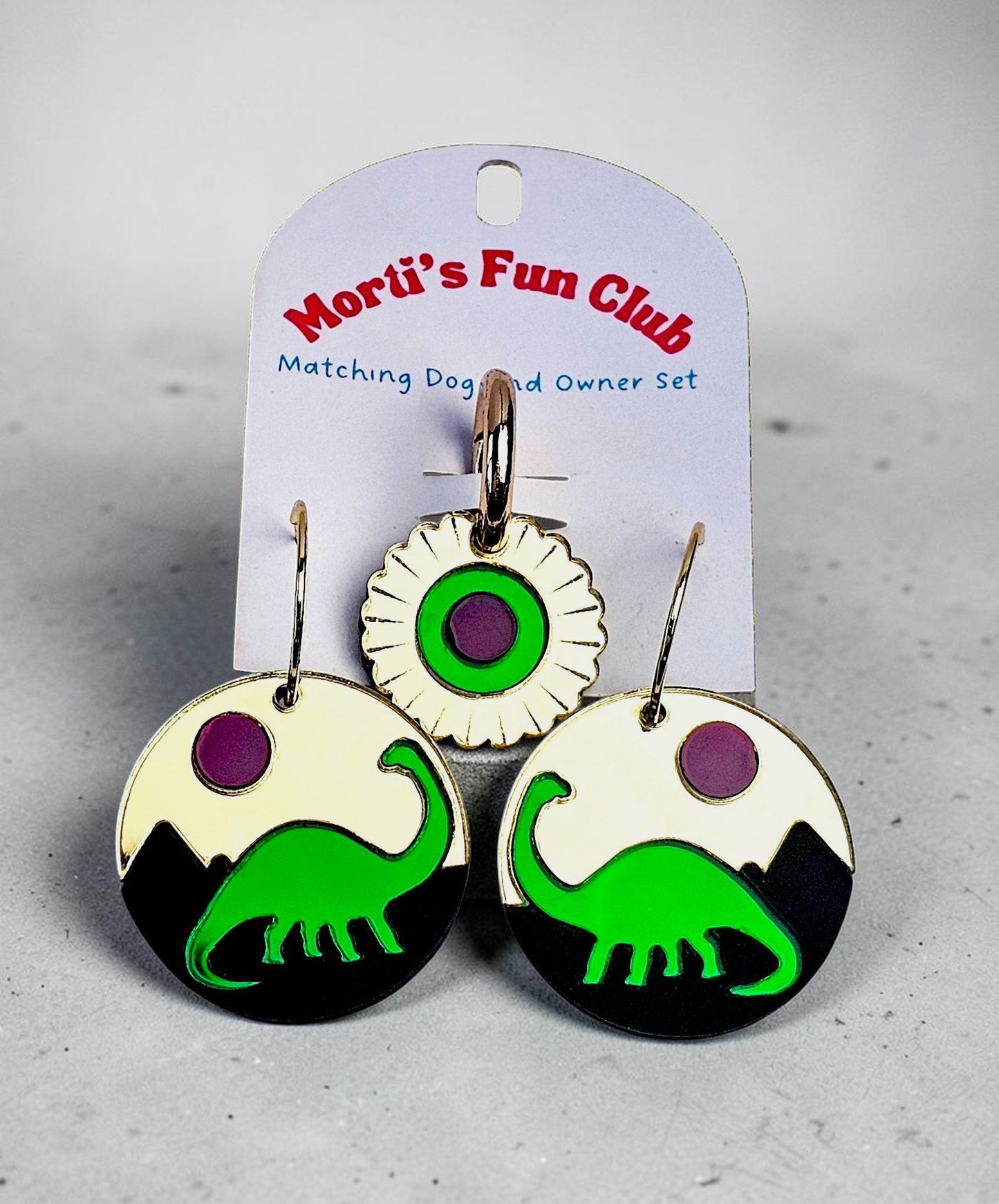 Morti's Fun Club Jurassic Moonrise twinning set with green dinosaur earrings and matching floral pet collar charm.
