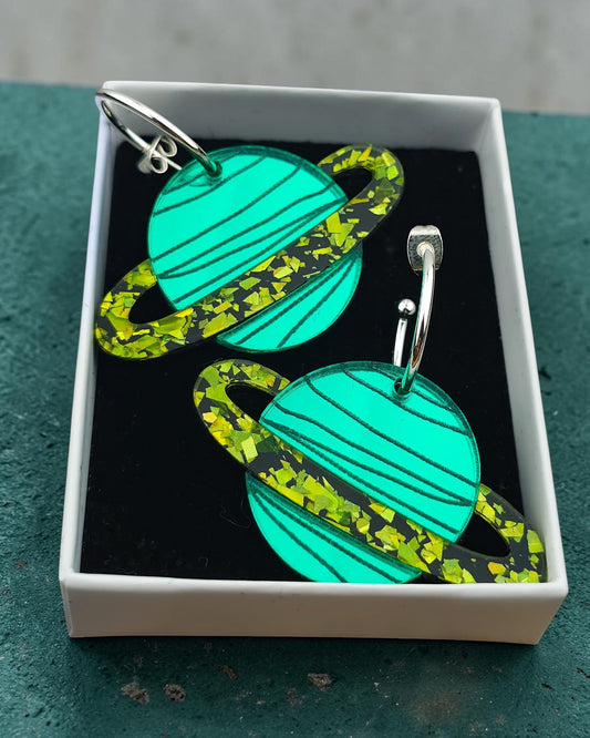 Morti's Fun Club Galaxylicious Green solar system hoop earrings featuring mirrored teal planets and lime glitter rings.