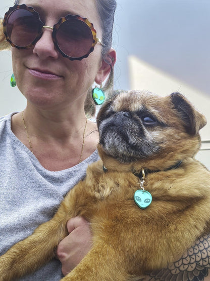 Morti's Fun Club twinning set featuring green alien hoop earrings on a woman and a matching dog collar charm