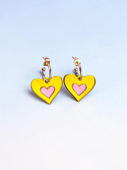Morti's Fun Club Candy Canary heart earrings in yellow and pink mirrored acrylic with gold-plated hoops.