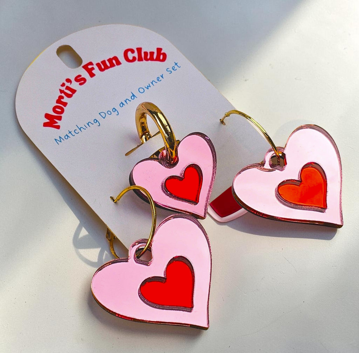 Morti's Fun Club Cherry Blossom twinning set featuring pink heart earrings and a matching dog collar charm.