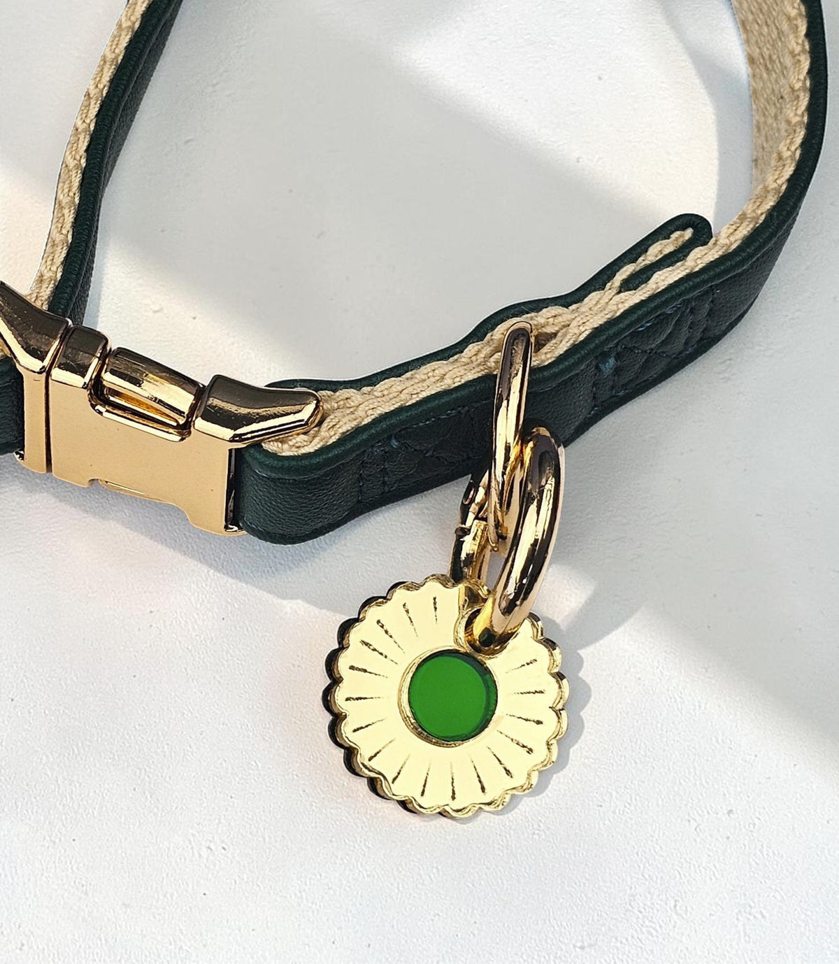 Morti's Fun Club Jurassic Bloom dog collar charm in gold-plated metal with a green acrylic center on a green collar.