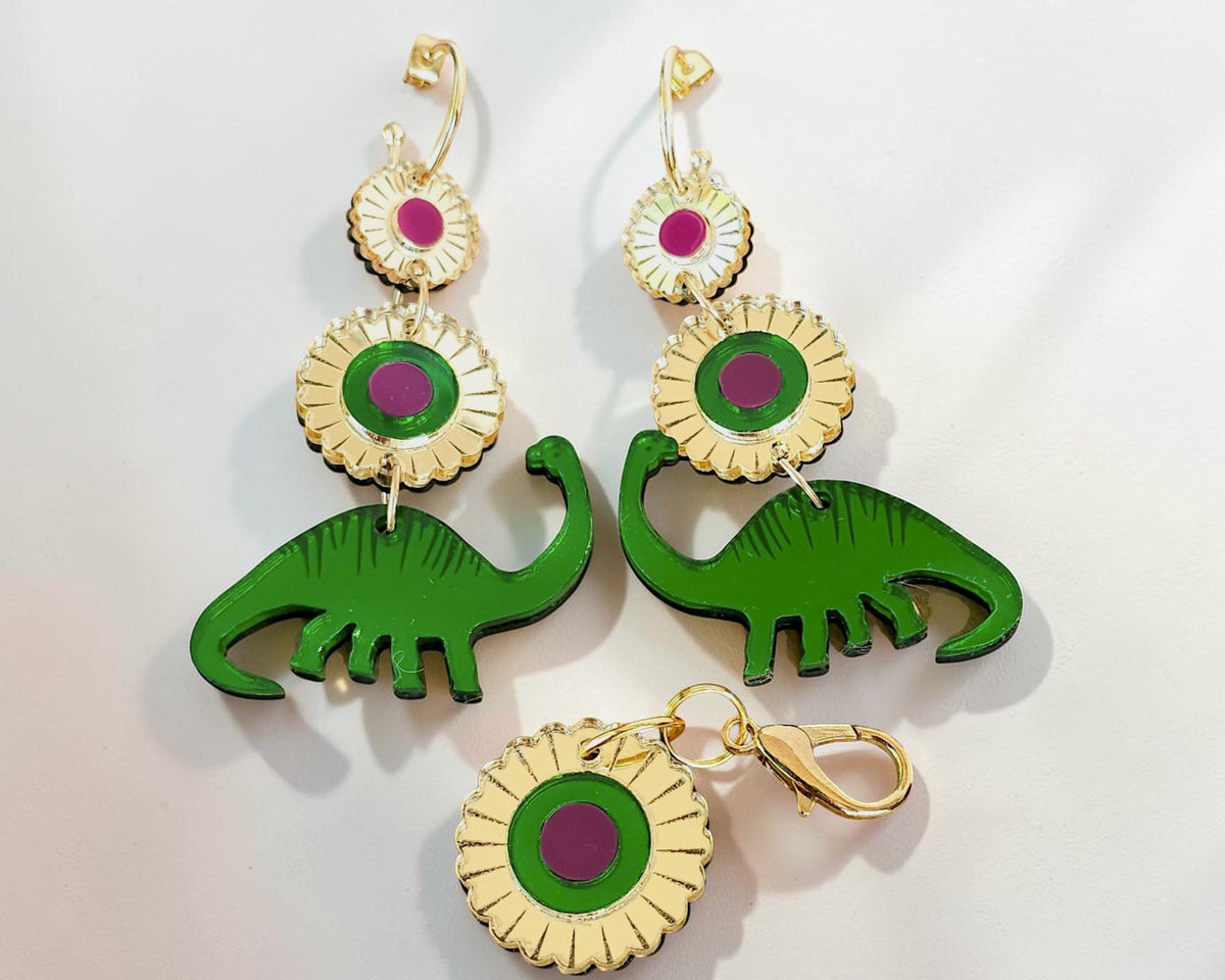 Morti's Fun Club Dino Royalty twinning set with green dinosaur earrings and a matching floral dog collar charm.