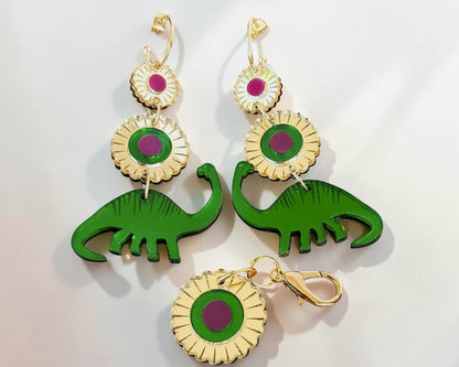 Morti's Fun Club Dino Royalty twinning set with green dinosaur earrings and a matching floral dog collar charm.