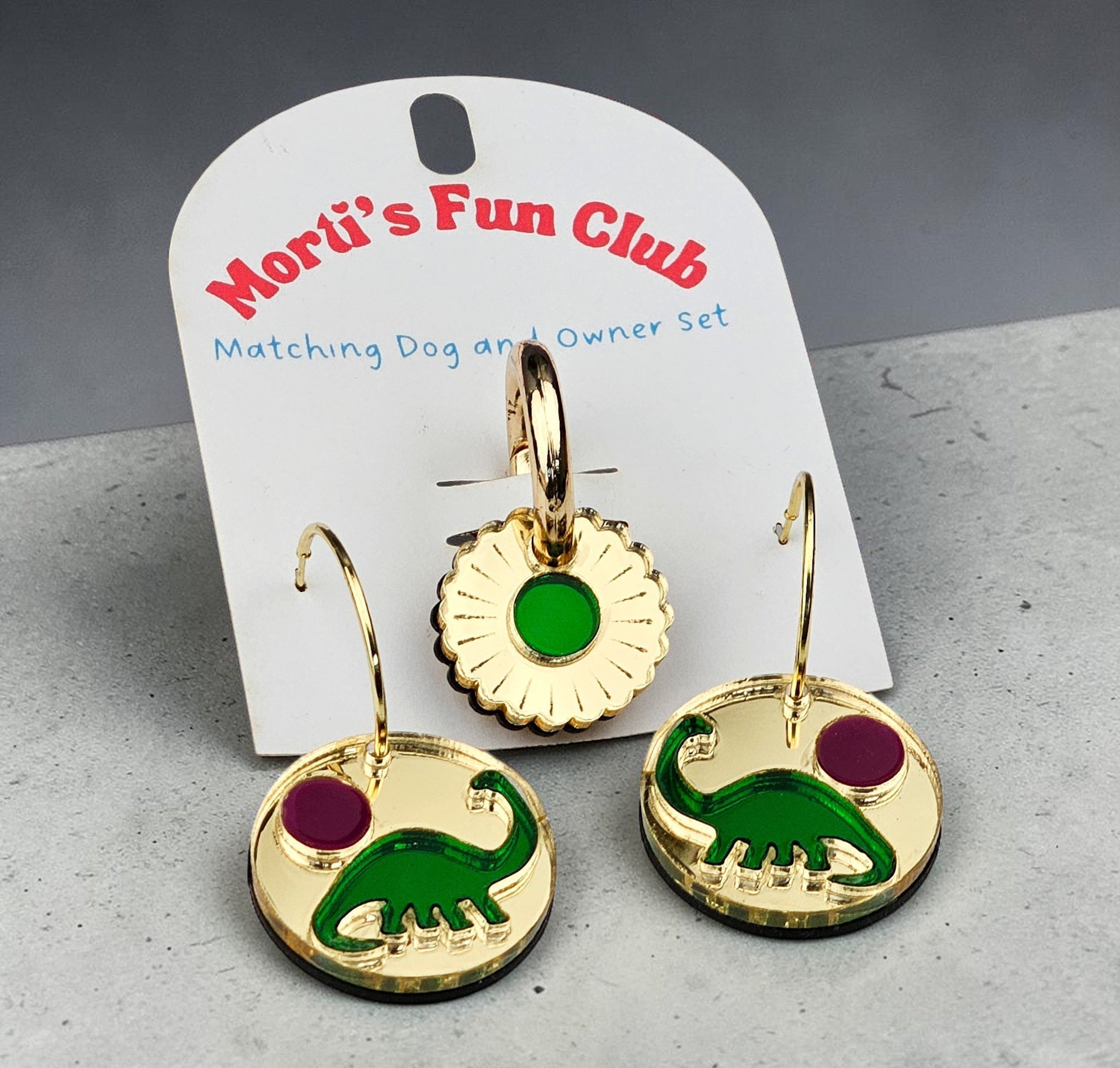 Morti's Fun Club Tiny Dino Twinning Set featuring gold-mirrored acrylic earrings and a matching dog collar charm.