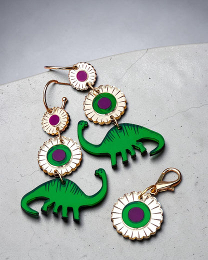 Morti's Fun Club Jurassic Bloom charm and earrings featuring green acrylic dinosaurs and purple floral accents.