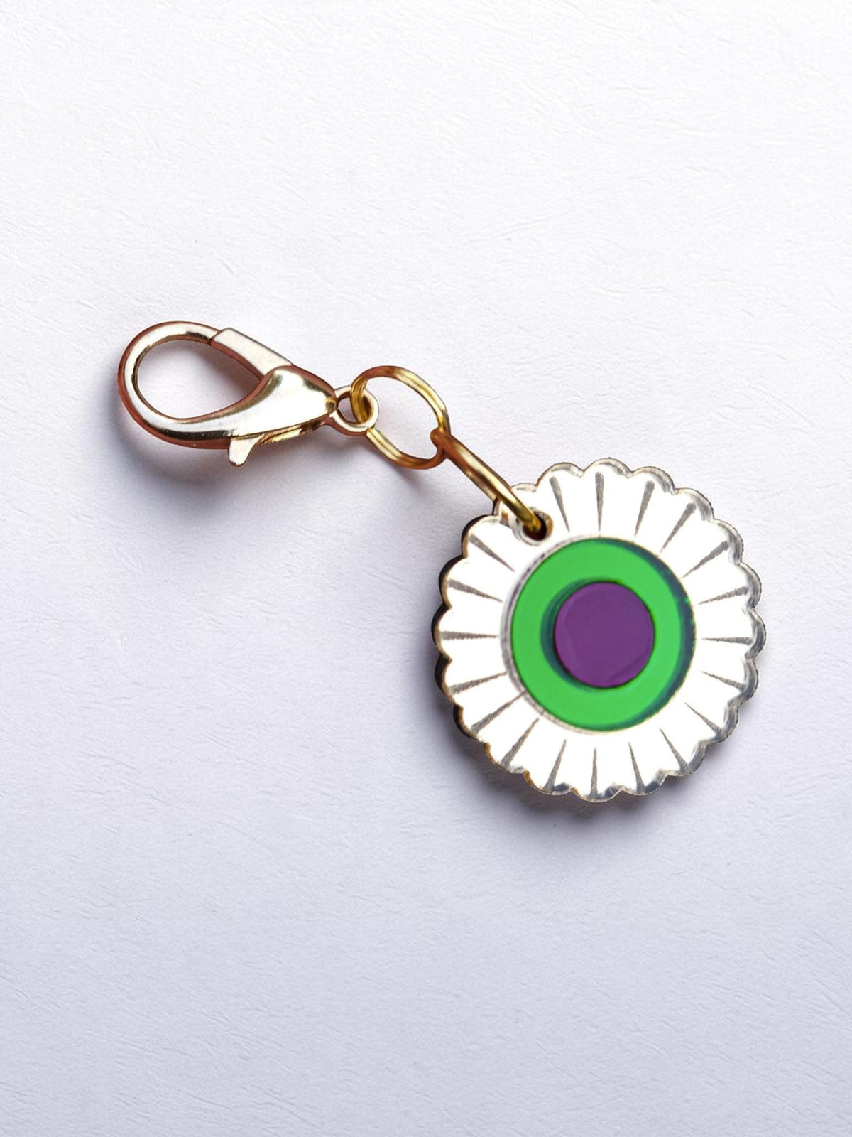 Morti's Fun Club Jurassic Bloom collar charm with a retro flower design in mirror acrylic, green, and purple.