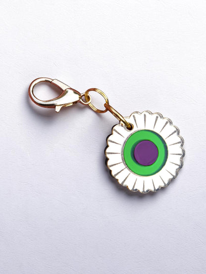 Morti's Fun Club Jurassic Bloom collar charm with a retro flower design in mirror acrylic, green, and purple.