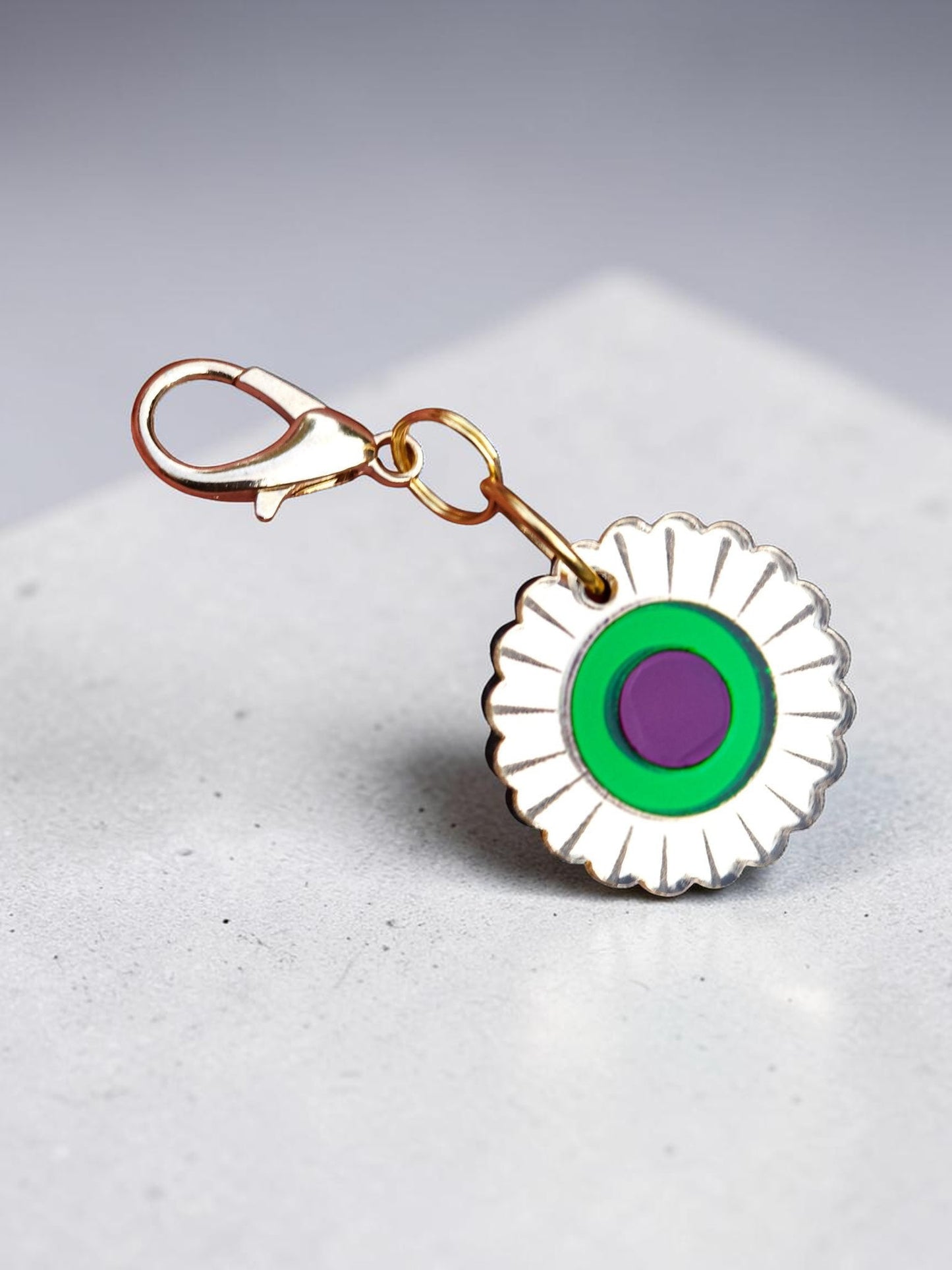 Morti's Fun Club Jurassic Bloom collar charm with a retro flower design in mirror acrylic, green, and purple.