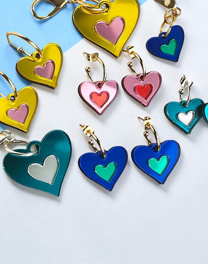 Morti's Fun Club I Heart Dogs heart-shaped mirrored acrylic earrings in various bright colourways with gold hoops.