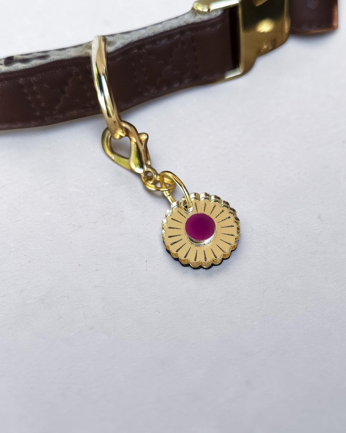 Morti's Fun Club Jurassic Bloom collar charm featuring a gold mirror acrylic flower with a vibrant purple centre.