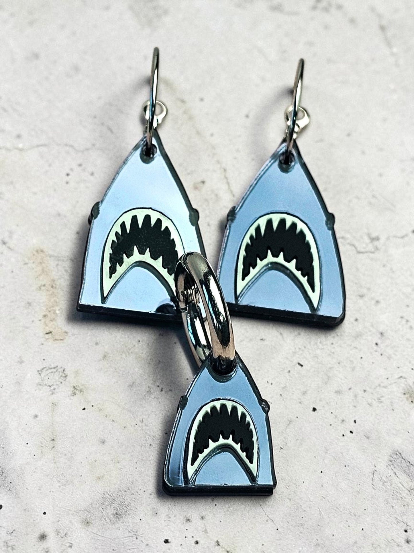 Morti's Fun Club shark twinning set featuring mirrored silver acrylic earrings and a matching dog collar charm.
