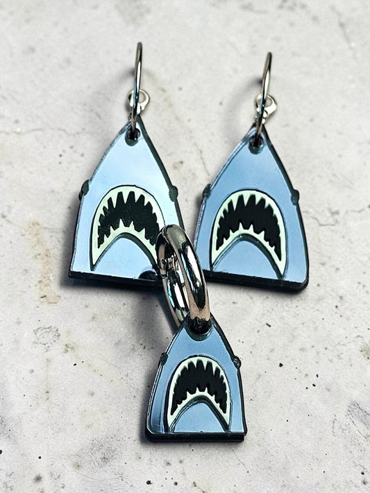 Morti's Fun Club shark twinning set featuring mirrored silver acrylic earrings and a matching dog collar charm.