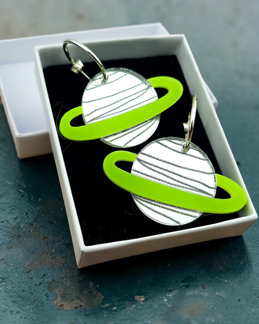 Morti's Fun Club Spacehopper Silver solar system earrings with mirrored silver planets and lime green rings in a box.