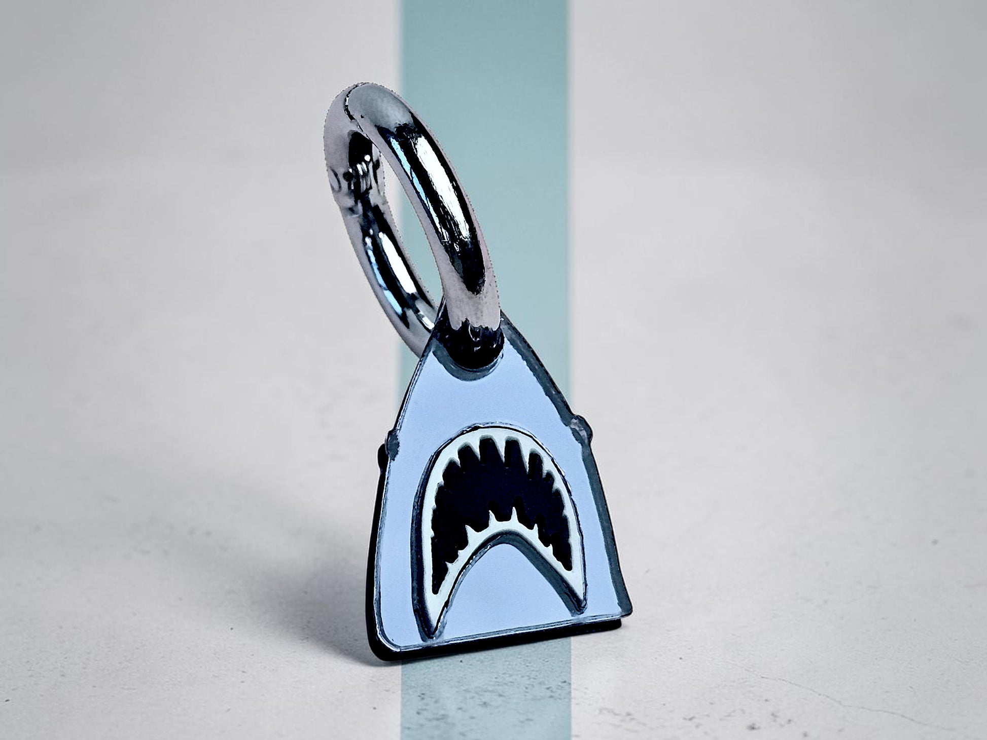 Morti's Fun Club Bite Me shark collar charm in silver mirror acrylic with black and white details on a lobster clasp.