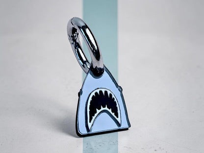 Morti's Fun Club Bite Me shark collar charm in silver mirror acrylic with black and white details on a lobster clasp.
