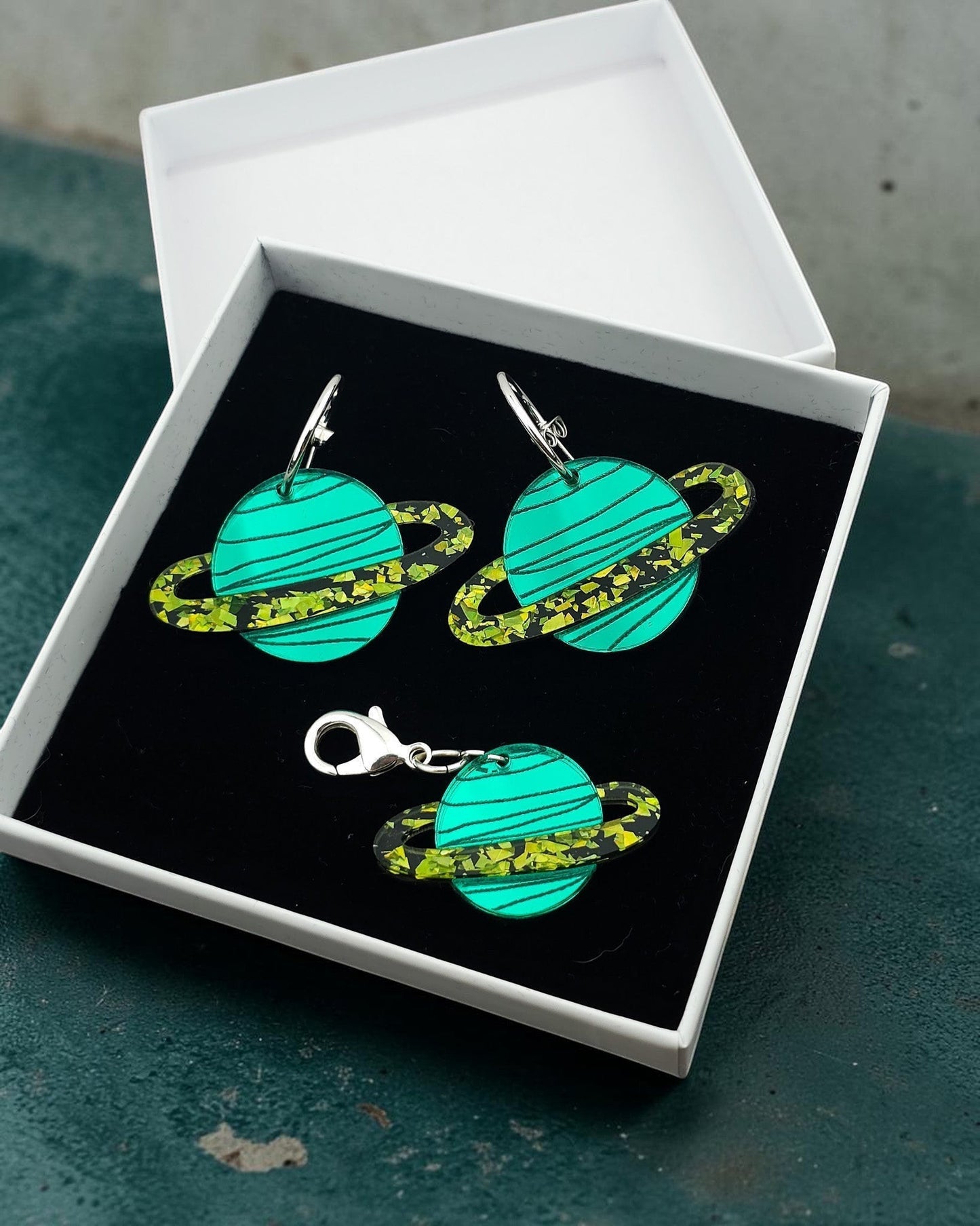 Morti's Fun Club Galaxylicious Green acrylic planet earrings and matching collar charm in a gift box.