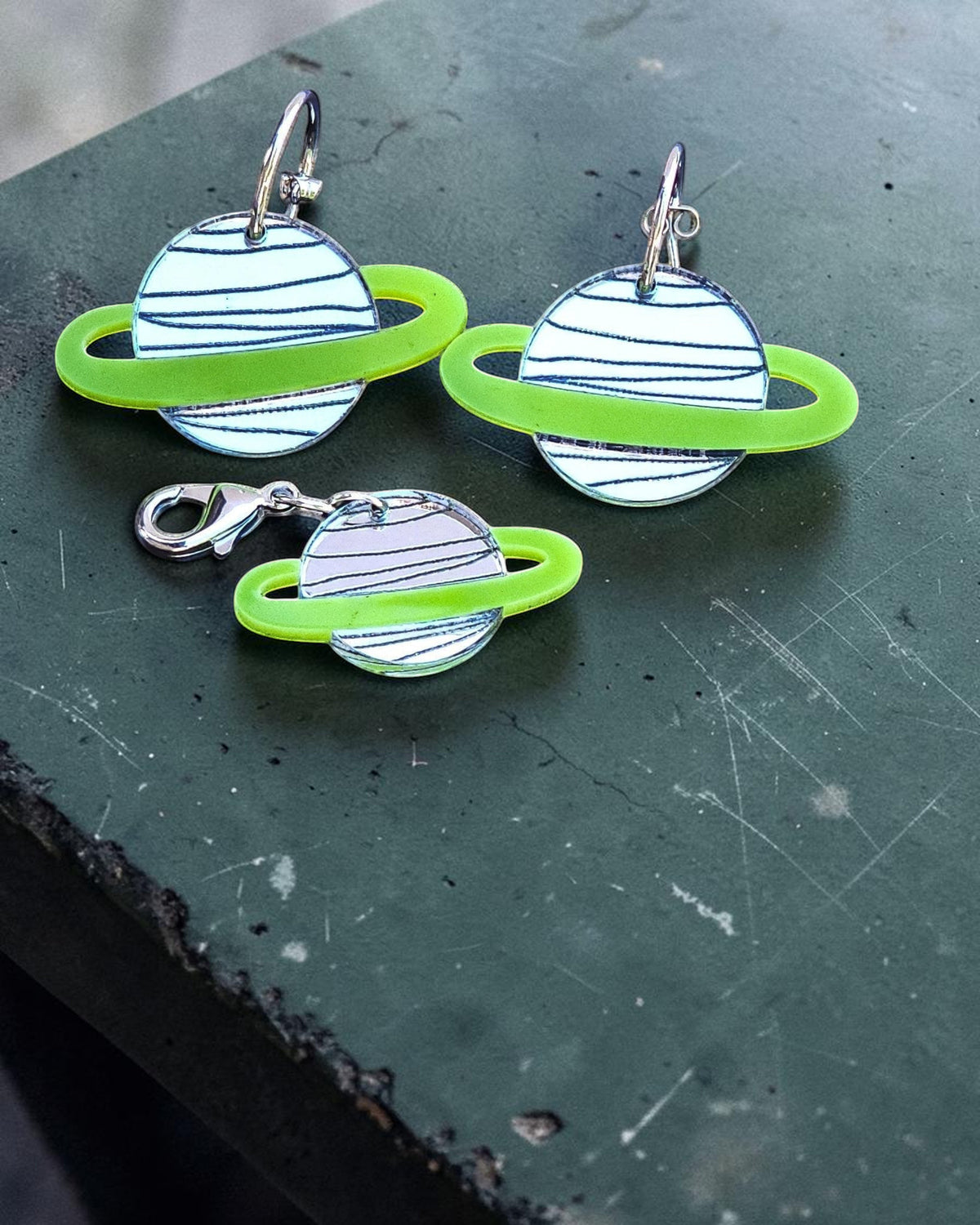 Morti's Fun Club Solar System earrings and matching collar charm in Galaxylicious Green acrylic with silver accents.