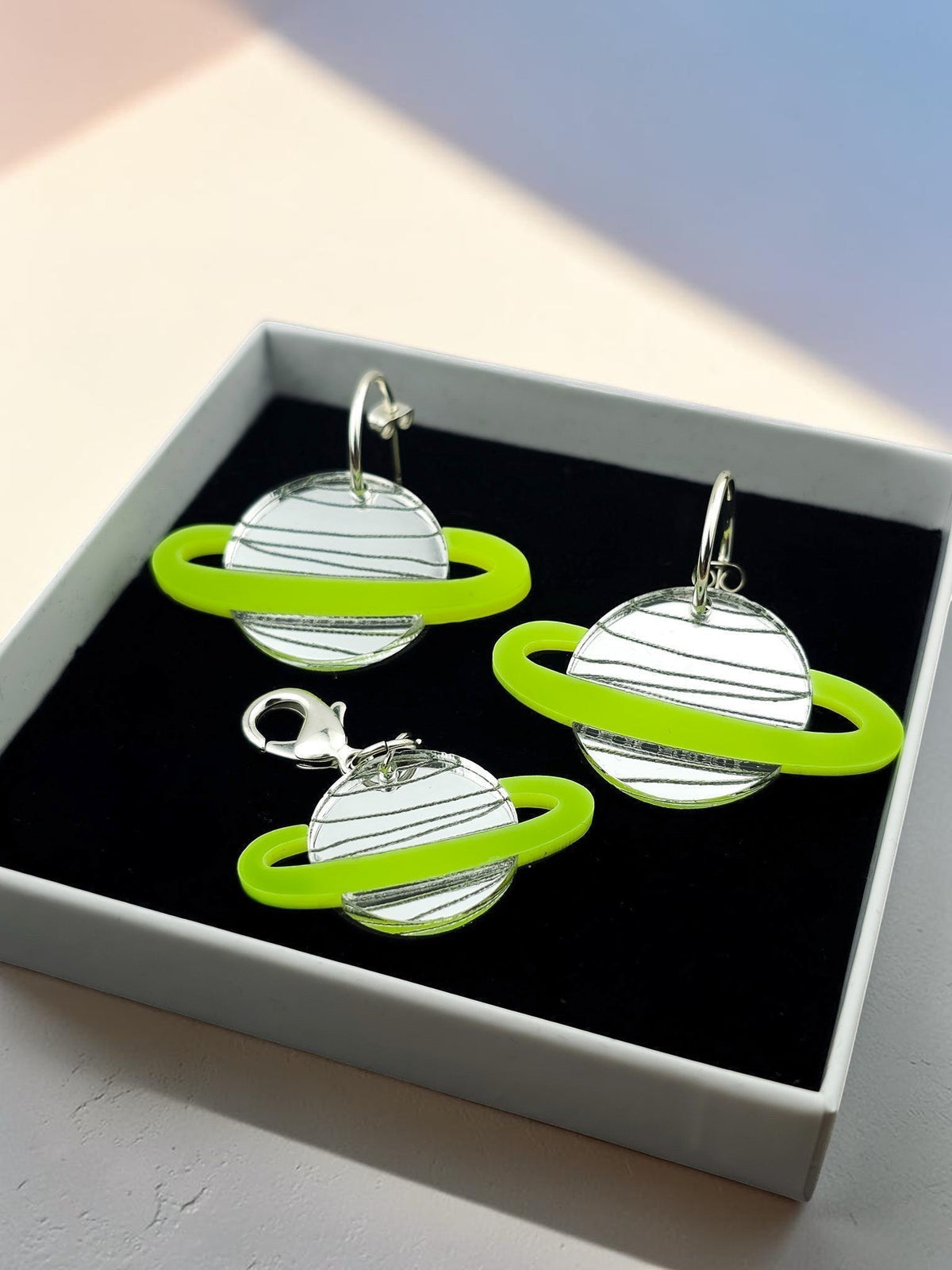 Morti's Fun Club Solar System earrings and collar charm set in Spacehopper Silver with lime fluro rings in a gift box.