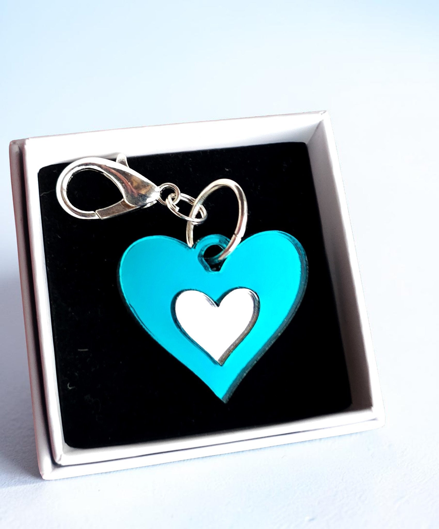 Morti's Fun Club Ice Queen heart collar charm in shimmering teal and silver acrylic with a silver-plated clip.