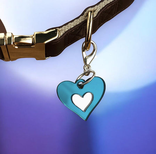Morti's Fun Club Ice Queen heart collar charm in shimmering teal and silver acrylic attached to a brown dog collar.