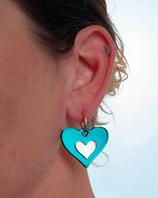 Morti's Fun Club Ice Queen heart-shaped teal and silver acrylic earring on a silver-plated hoop