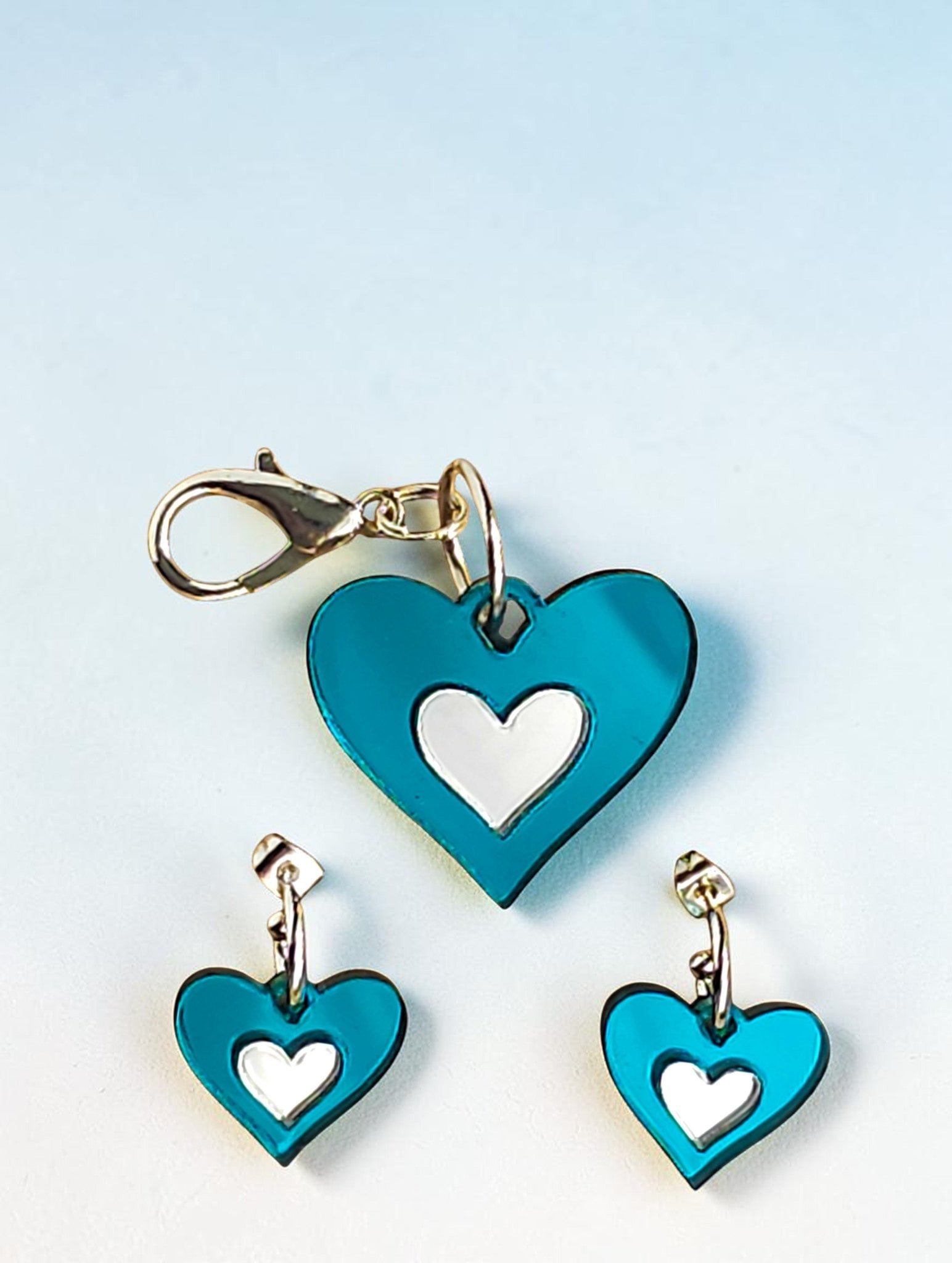Morti's Fun Club Ice Queen twinning set featuring teal and silver mirrored heart earrings and a matching dog charm.