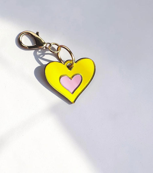 Morti's Fun Club Canary Candy heart collar charm in yellow and pink acrylic with a gold-plated lobster clasp.